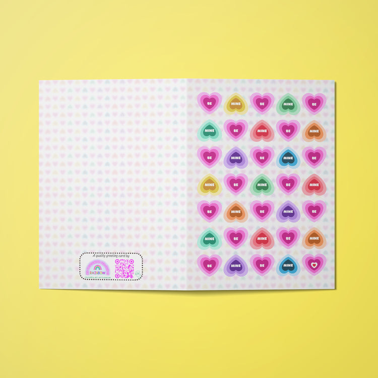 The Be Mine Valentines card from My Store features heart-shaped designs on a white background with the phrase "Be Mine".  Perfect as your go-to Valentines Day card!.