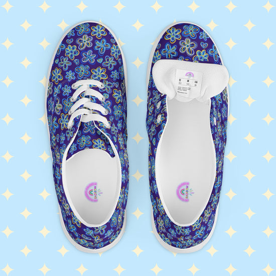 The Bloomscape Canvas Sneakers by My Favourite Colour is Rainbow, featuring a blue floral design. . The underside of the shoe tongue has a shoe size sticker and the inside of the shoe is white with My Favourite Colour is Rainbow branding on the footbed.
