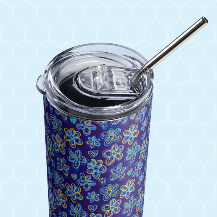 A close-up of the The Bloomscape Stainless Steel Tumbler by My Favourite Colour is Rainbow showing the lid, and  metal straw.  The design features large flowers and small hearts in shades of blue and yellow on a royal blue background.