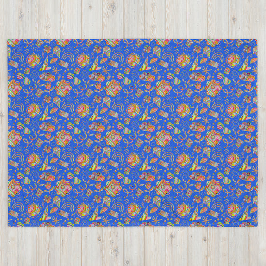 The Blue Summer Sorbet Throw Blanket by My Favourite Colour is Rainbow features a cosy blue design with symmetrical patterns, abstract shapes, stars, and swirls in lively orange, green, and purple.