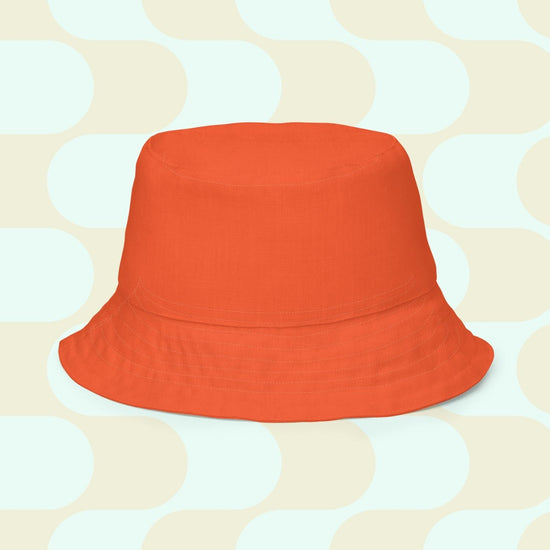 The orange reverse side of the Colour Block reversible bucket hat.