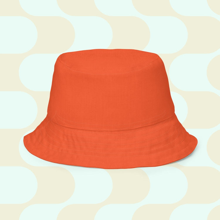 The orange reverse side of the Colour Block reversible bucket hat.