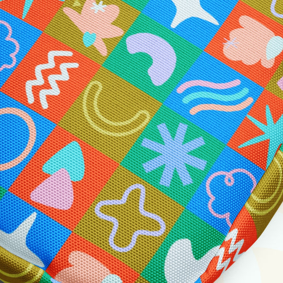 The Colour Block Mini Crossbody Bag from My Favourite Colour is Rainbow boasts a vibrant grid of green, red, and blue squares with abstract stars, clouds, waves, and swirls. This sturdy bag features a colorful textured pattern thats water-resistant with adjustable straps for comfort.