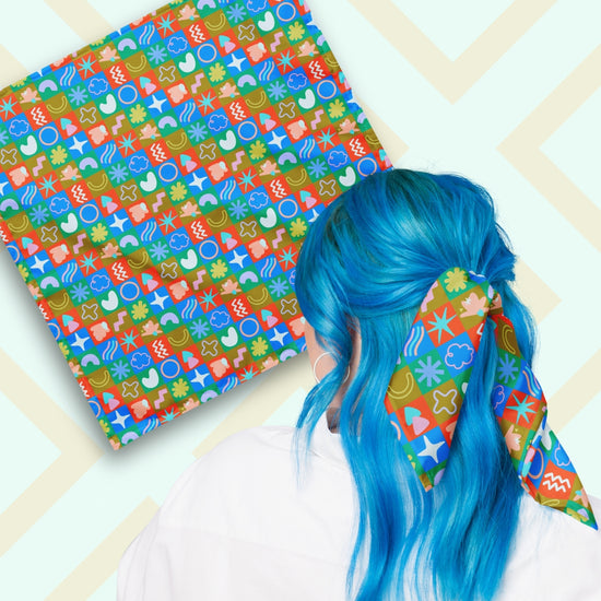 Two views of the 'Colour Block' Bandana by My Favourite Colour is Rainbow.  At top left, a flat lay of the bandana.  At bottom right, a person with vibrant blue hair is seen from behind, wearing the bandana in her hair.