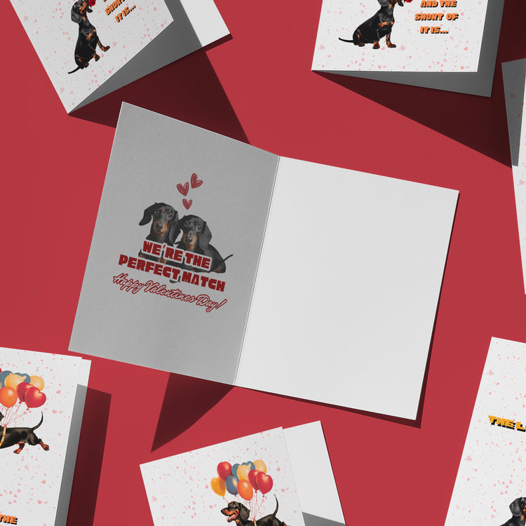 Celebrate Valentines Day with My Stores Perfect Match Dachshund Valentines Card, showcasing two lovable dachshunds under hearts, exclaiming We’re the perfect match. Happy Valentine’s Day! and accompanied by a selection of cards featuring dachshunds spreading love with balloons.