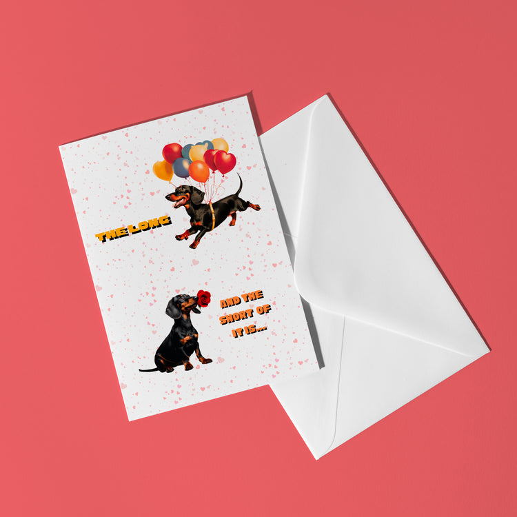 The Perfect Match Dachshund Valentines Card by My Store features cute dachshunds: one with balloons labeled The Love and the other with a heart gift saying ...and one more of it! It sits on a white envelope against a pink background.