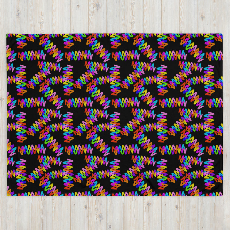 Discover the Electric Zigzag Throw Blanket by My Favourite Colour is Rainbow, featuring bold zigzag patterns in pink, orange, blue, green, and yellow on a black backdrop. This vibrant design creates a dazzling kaleidoscopic effect that enhances any space with its soft fabric charm.