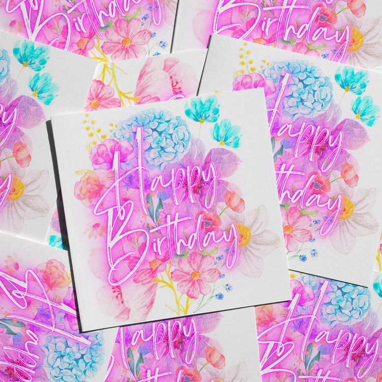 The Floral Happy Birthday Card from My Store features a collage of birthday cards with watercolor floral designs in blue, pink, and purple hues, adorned with Happy Birthday in vibrant pink cursive text.
