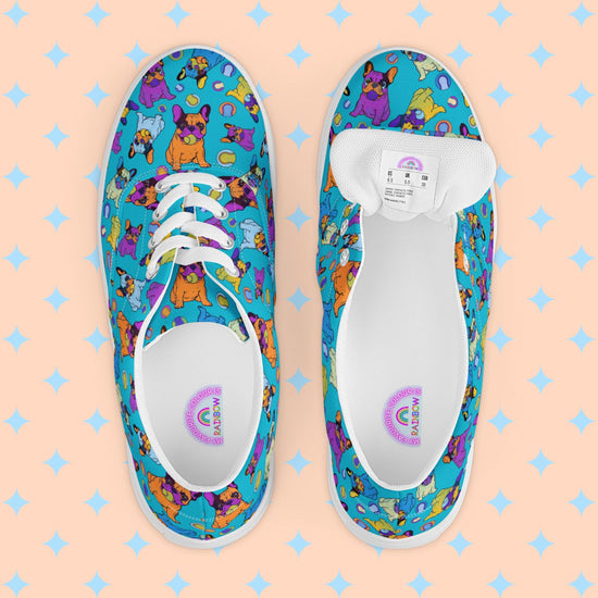 Frenchie Fetch, Set, Match Canvas Sneakers by My Favourite Colour is Rainbow are womens lace-up shoes featuring playful cartoon French Bulldogs on a vibrant background. The inside of the shoe is white with My Favourite Colour is Rainbow branding on the footbed.  They include white laces and soles with a breathable lining for added comfort.