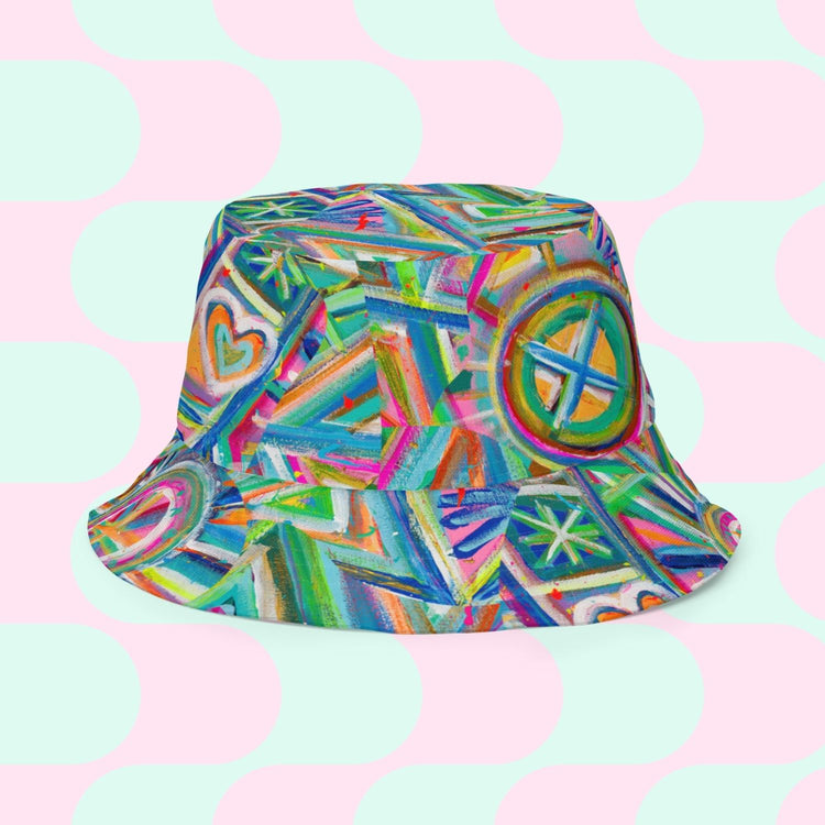 Introducing the Geometric Rainbow/Love in Neon Reversible Bucket Hat by My Favourite Colour is Rainbow—a vibrant accessory with abstract geometric and heart patterns. Its pastel pink and mint green circles offer a Love in Neon charm, providing two stylish looks in one chic design.
