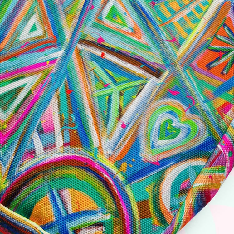 The Geometric Rainbow Mini Crossbody Bag by My Favourite Colour is Rainbow showcases a close-up of an abstract pattern with vibrant geometric shapes—triangles, circles, and hearts in blue, green, orange, pink, and yellow—for a dynamic and energetic look.