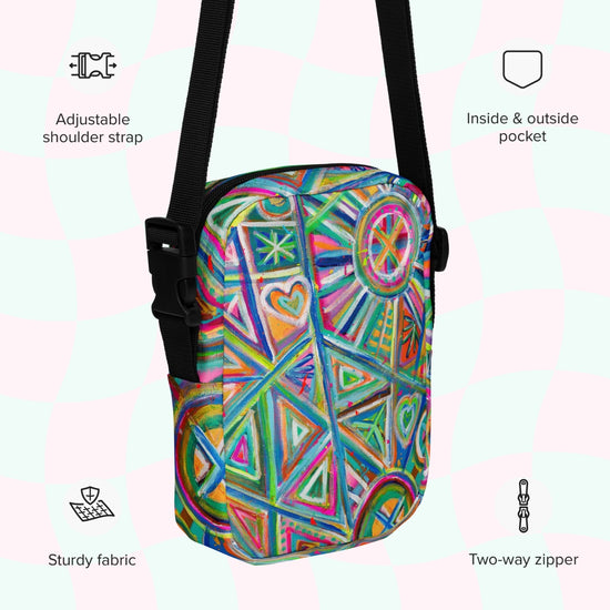 The Geometric Rainbow Mini Crossbody Bag from My Favourite Colour is Rainbow features a colorful geometric print, adjustable strap, two-way zipper, inside and outside pocket, and sturdy fabric on a pastel background with icons highlighting these attributes.