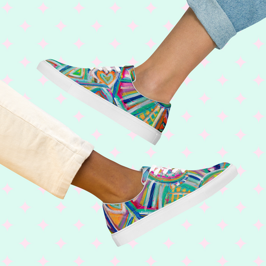 Two individuals showcase their vibrant style with Geometric Rainbow Canvas Sneakers by My Favourite Colour is Rainbow: one in light pants, the other in rolled-up jeans. The vibrant sneakers feature a colourful abstract design and white soles.