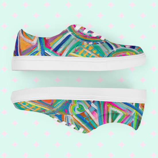 Geometric Rainbow Canvas Sneakers by My Favourite Colour is Rainbow feature vibrant canvas adorned with abstract patterns. Bright blue, pink, and green hues create a striking Geometric Rainbow effect against a light mint background with playful pink diamond shapes.