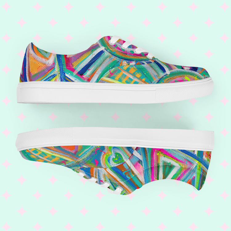 Geometric Rainbow Canvas Sneakers by My Favourite Colour is Rainbow feature vibrant canvas adorned with abstract patterns. Bright blue, pink, and green hues create a striking Geometric Rainbow effect against a light mint background with playful pink diamond shapes.
