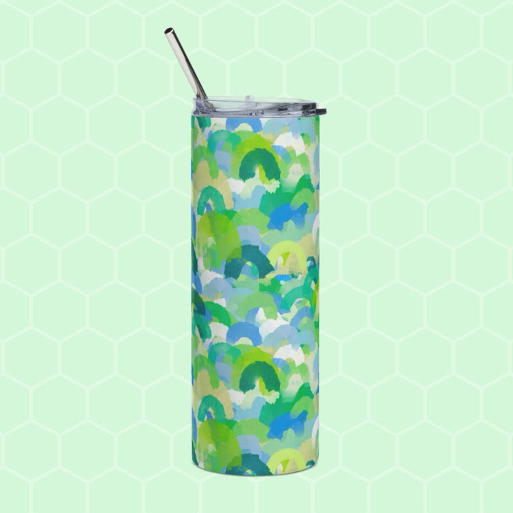 The Green Rainbow Stainless Steel Tumbler by My Favourite Colour is Rainbow features an abstract green, blue, and yellow design on a light green hexagonal background. It includes a transparent lid and a metal straw for reuse.