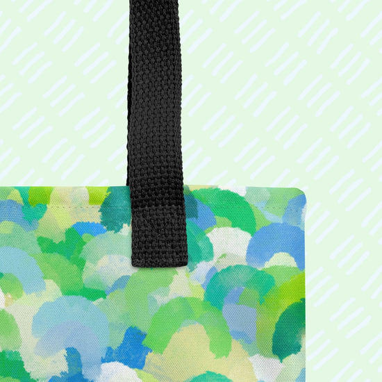 Close-up of the Green Rainbow Tote Bag by My Favourite Colour is Rainbow, showing the sturdy black strap and featuring an abstract green and blue rainbow pattern.