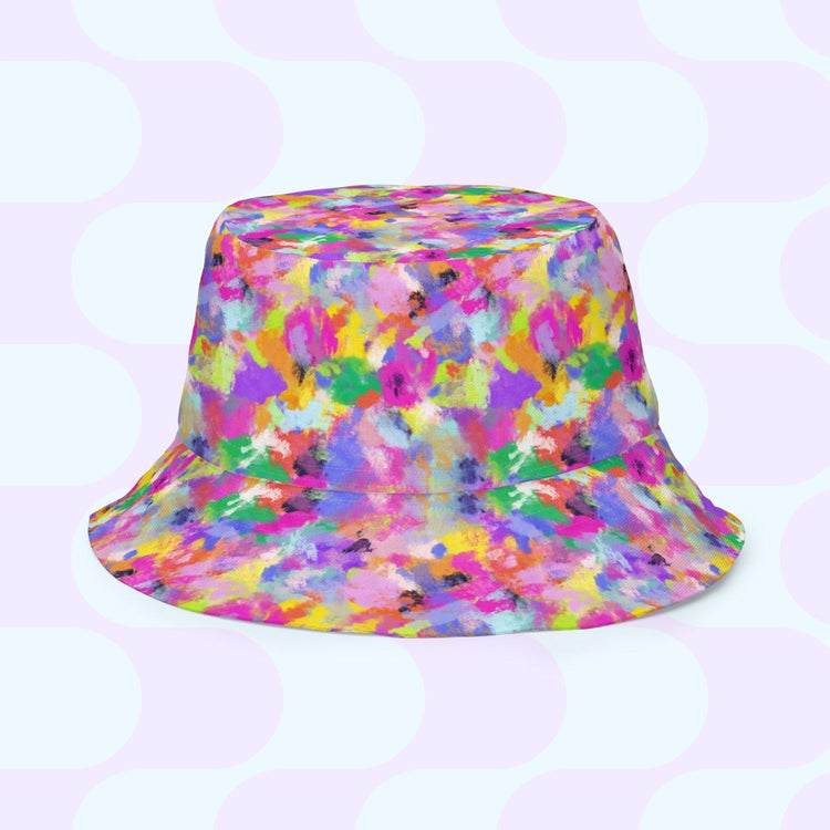 The Heart Attack/Watercolour Rainbow Reversible Bucket Hat by My Favourite Colour is Rainbow showcases vibrant abstract patterns in pink, blue, green, yellow, and purple on a light background. Available in multiple sizes, its the ideal Style BFF for any outfit.