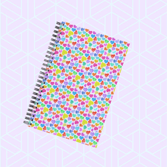 Introducing My Favourite Colour is Rainbow's Heart Attack Notebook—a vibrant addition to your collection. This spiral-bound gem showcases a colourful heart pattern with pink, blue, green, and yellow hearts on a geometric white and light turquoise backdrop, perfect for inspiring creativity.