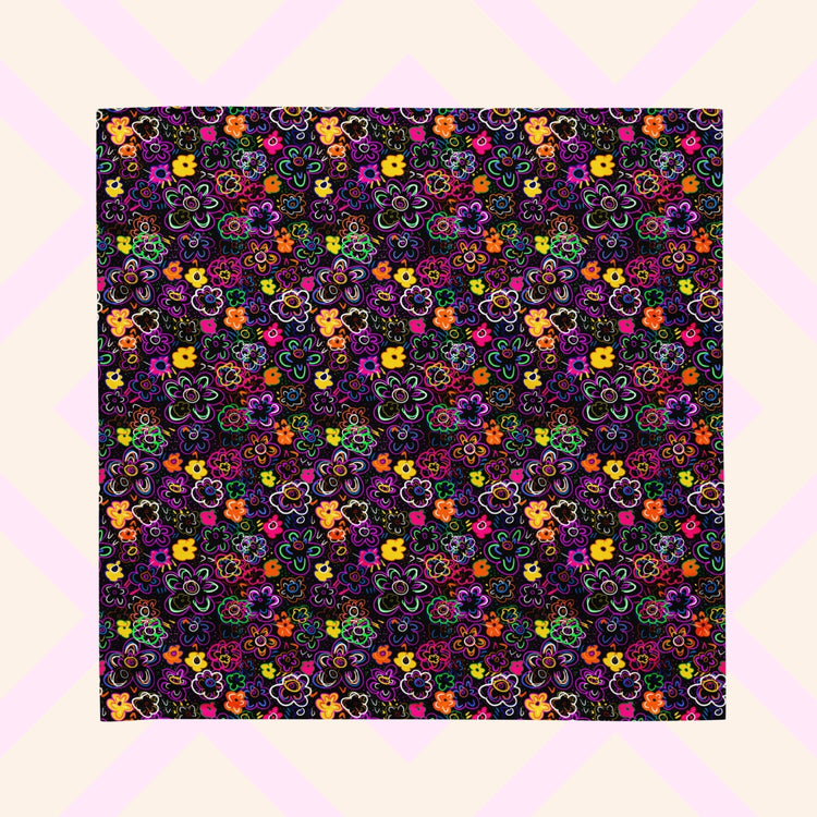 The 'In the Midnight Garden' Bandana by My Favourite Colour is Rainbow features a vibrant floral pattern with pink, orange, yellow, purple, and green flowers on a dark backdrop.
