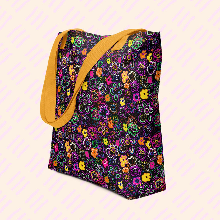The In the Midnight Garden Tote Bag by My Favourite Colour is Rainbow features a floral pattern in orange, purple, pink, and green on black with yellow handles.
