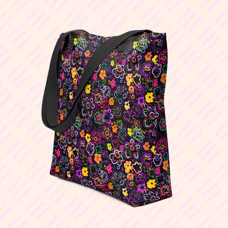The In the Midnight Garden Tote Bag by My Favourite Colour is Rainbow features a floral pattern in orange, purple, pink, and green on black with black handles.