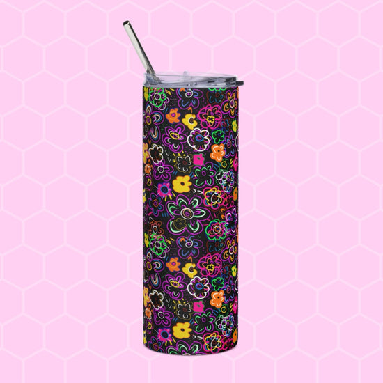 The In the Midnight Garden Stainless Steel Tumbler from My Favourite Colour is Rainbow features a vibrant floral pattern on a black background, complete with a lid and metal straw, perfectly enhanced by a pink hexagonal setting.