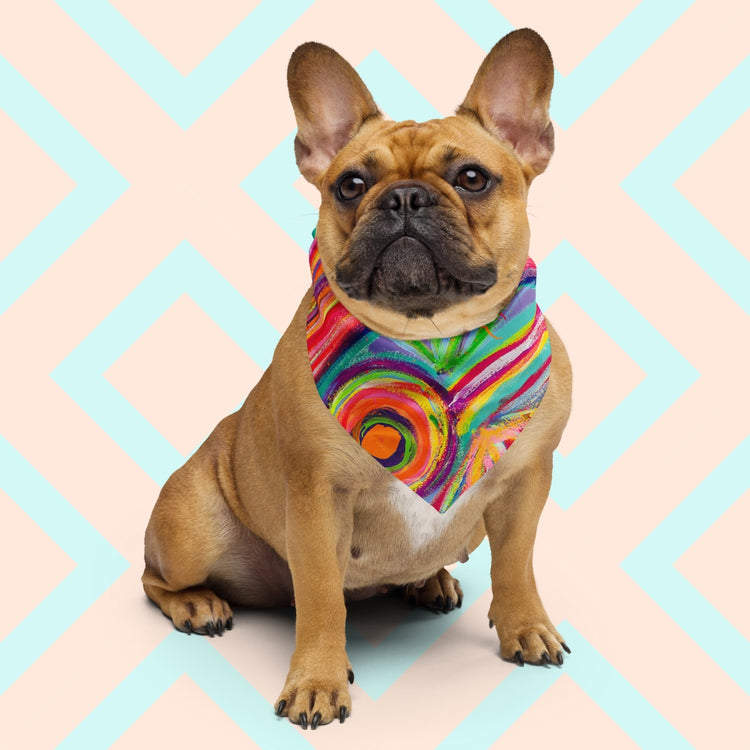 A brown French Bulldog wearing the Karma Kaleidoscope Bandana by My Favourite Colour is Rainbow, sits against a pastel geometric backdrop.