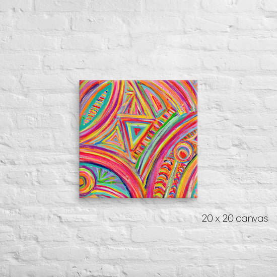 The Karma Kaleidoscope Canvas Artwork by My Favourite Colour is Rainbow features vibrant swirls, circles, and triangles on a 20x20 canvas, coming alive against a white brick wall.