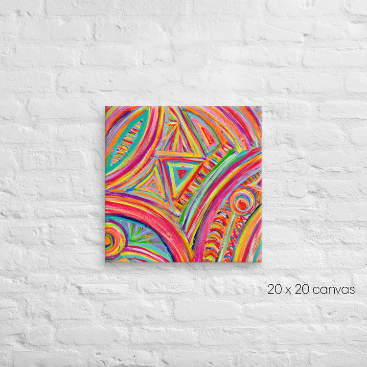 The Karma Kaleidoscope Canvas Artwork by My Favourite Colour is Rainbow features vibrant swirls, circles, and triangles on a 20x20 canvas, coming alive against a white brick wall.
