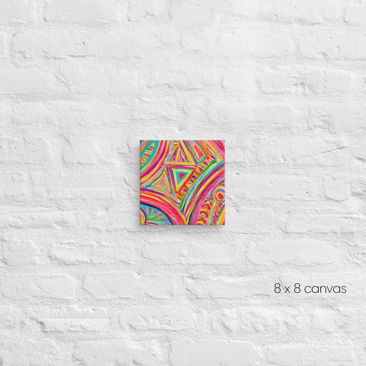 The Karma Kaleidoscope Canvas Artwork by My Favourite Colour is Rainbow, featuring colorful abstract geometric patterns, hangs on a white brick wall. Below it reads 8 x 8 canvas.
