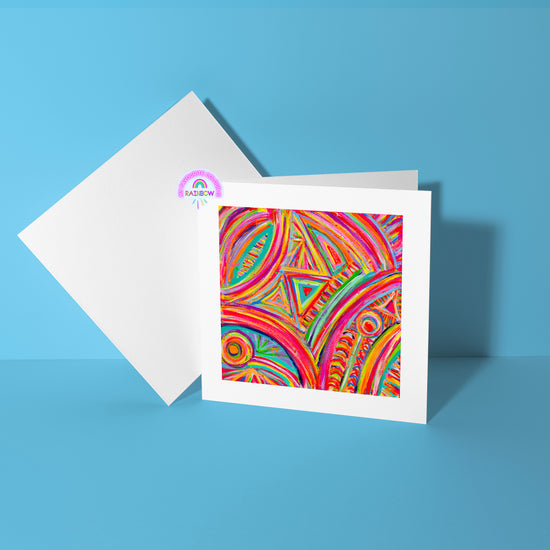 The Karma Kaleidoscope Greeting Card by My Store features vibrant abstract geometric patterns in red, orange, yellow, and green set against a bright blue background. A blank white card is included behind it for added elegance.