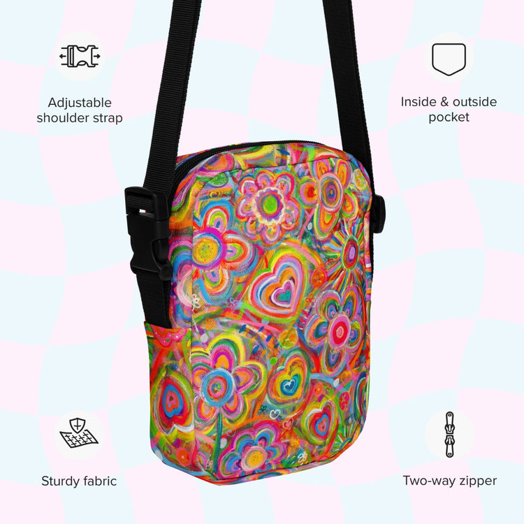 An infographic highlighting features of the Love in Neon Mini Crossbody Bag by My Favourite Colour is Rainbow: adjustable shoulder strap, inside and outside pocket, sturdy canvas fabric and a two-way zipper.