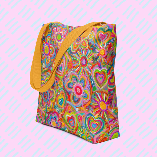 The Love in Neon Tote Bag by My Favourite Colour is Rainbow features my Love in Neon painting, with vibrant heart and abstract flower designs in pinks, greens, yellows, and blues. Its spacious, hard-wearing design includes sturdy yellow handles making it the perfect work tote.