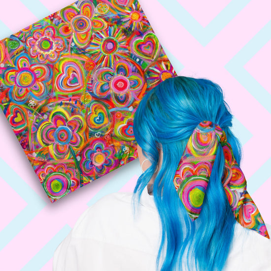 Two views of the 'Love in Neon' Bandana by My Favourite Colour is Rainbow.  At top left, a flat lay of the bandana.  At bottom right, a person with vibrant blue hair is seen from behind, wearing the bandana in her hair.  The bandana features my vibrant acrylic-on-canvas painting with overlapping hearts, flowers and suns in bright pink, blue, green, and orange hues.