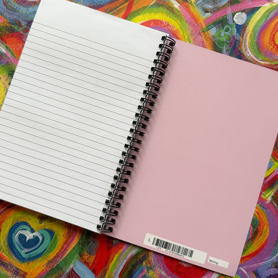 The Love in Neon Notebook from My Store, featuring lined pages on the left and a vibrant pink cover on the right, rests against an abstract swirl and heart background, perfectly embodying creativity to complement any stationery collection.