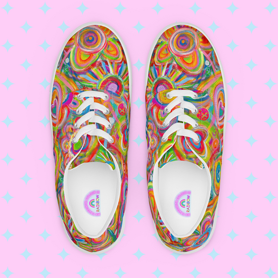 Top view of Love in Neon Canvas Sneakers by My Favourite Colour is Rainbow showcases vibrant abstract spirals in pink, yellow, green, and blue on a pink backdrop with light blue diamonds. Accentuated by white laces and trim for added style.