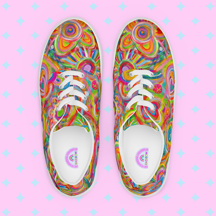 Top view of Love in Neon Canvas Sneakers by My Favourite Colour is Rainbow showcases vibrant abstract spirals in pink, yellow, green, and blue on a pink backdrop with light blue diamonds. Accentuated by white laces and trim for added style.