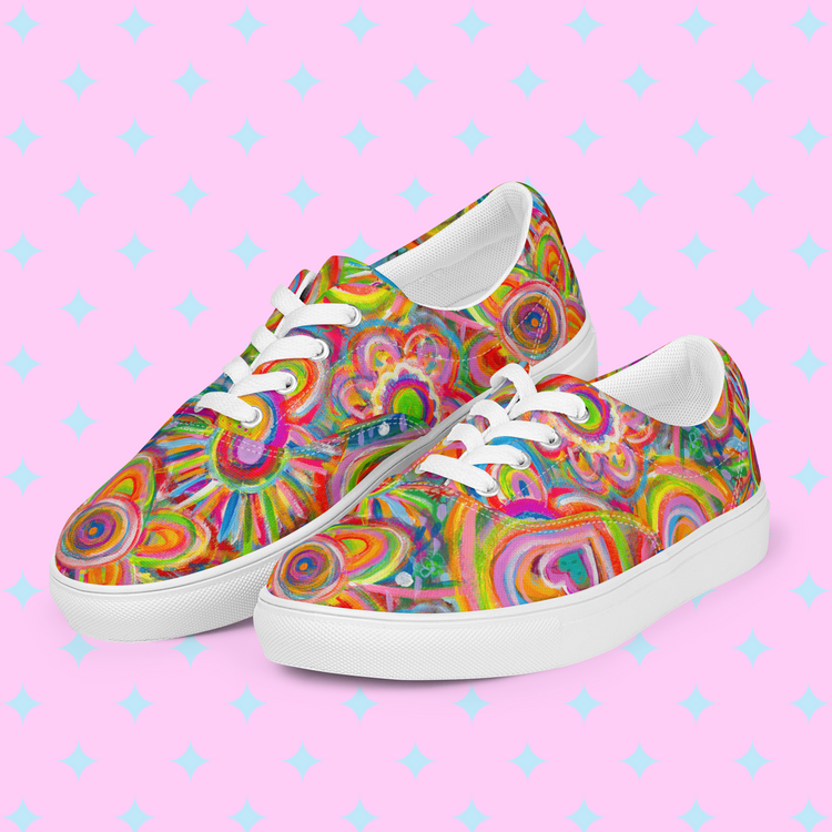 Love in Neon Canvas Sneakers by My Favourite Colour is Rainbow feature a vibrant abstract design with hearts and swirls in pink, orange, yellow, blue, and green on a pink background accented by a light blue diamond pattern.