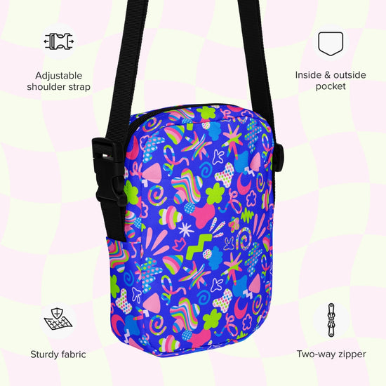 An infographic highlighting features of the Neon Carnival Mini Crossbody Bag by My Favourite Colour is Rainbow: adjustable shoulder strap, inside and outside pocket, sturdy canvas fabric and a two-way zipper.