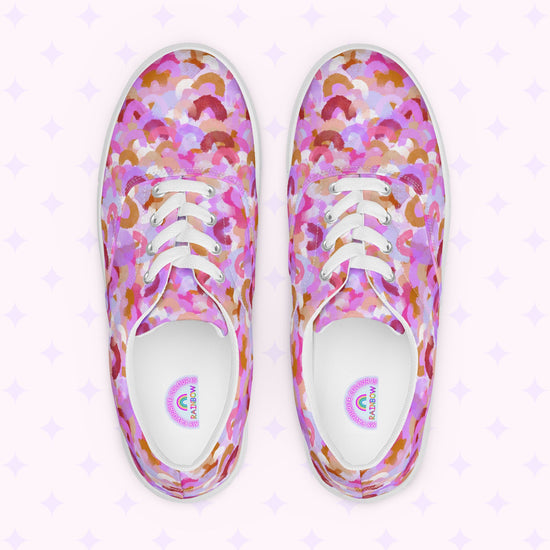Introducing My Favourite Colour is Rainbows Pink Rainbow Canvas Sneakers, featuring a vibrant abstract pattern in pink, purple, orange, and white. Complete with comfy fit, white laces, and soles against a subtle star-adorned backdrop.