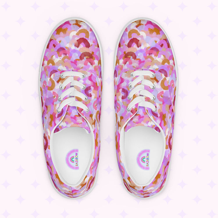 Introducing My Favourite Colour is Rainbows Pink Rainbow Canvas Sneakers, featuring a vibrant abstract pattern in pink, purple, orange, and white. Complete with comfy fit, white laces, and soles against a subtle star-adorned backdrop.