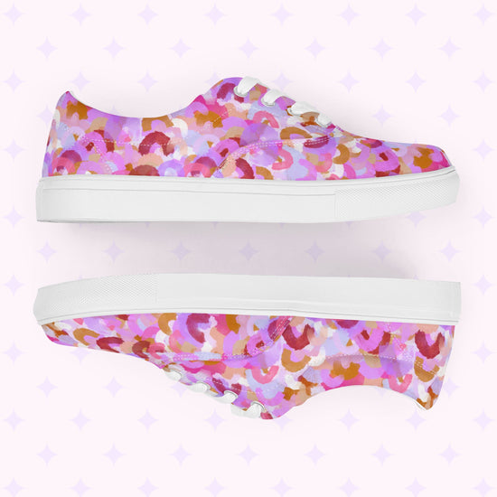 The Pink Rainbow Canvas Sneakers by My Favourite Colour is Rainbow showcase a colorful print of pink, purple, red, and brown abstract shapes. With a comfy fit, white soles and laces, these stylish shoes feature subtle purple star-like motifs.