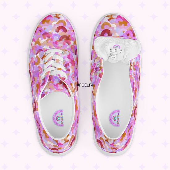 The Pink Rainbow Canvas Sneakers by My Favourite Colour is Rainbow feature vibrant pink, purple, orange, and brown prints. Set against a white background with faint purple stars, they offer a comfy fit. The color code #FCE1F4 is stylishly positioned between the shoes.