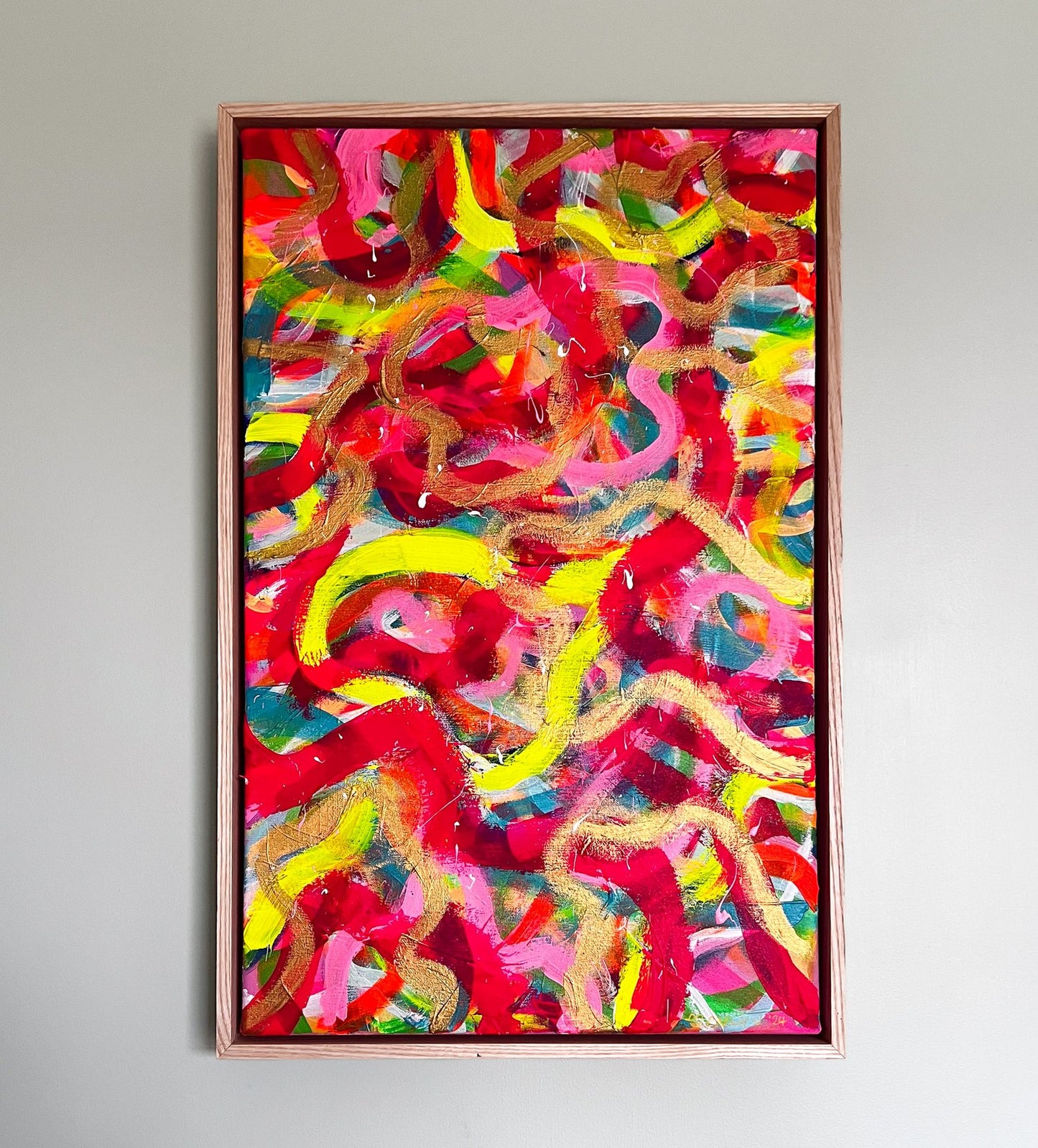 The Spaghetti Junction Framed Original Painting by My Store features vibrant swirls of red, yellow, pink, and green on a red background with light wood framing. Its energetic patterns and textured finish convey movement and dynamism.