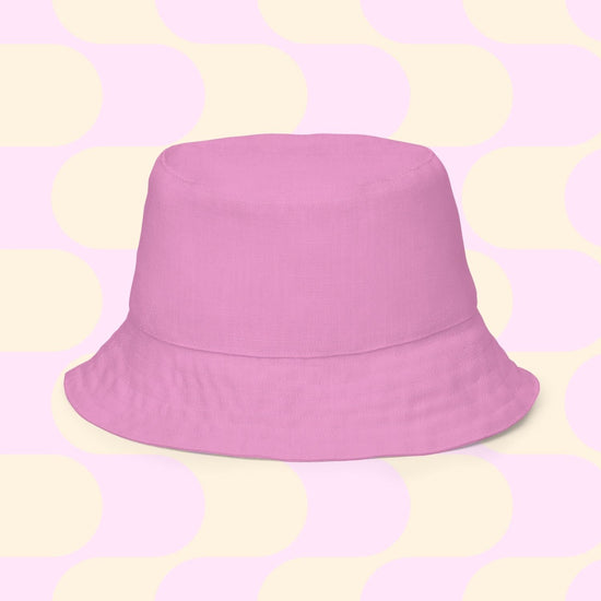 Centered on a pastel backdrop with cream and pink circles and rectangles, the chic Splotches and Crosses reversible bucket hat by My Favourite Colour is Rainbow, comes in multiple sizes. Perfect for matching your Style BFF on sunny days.