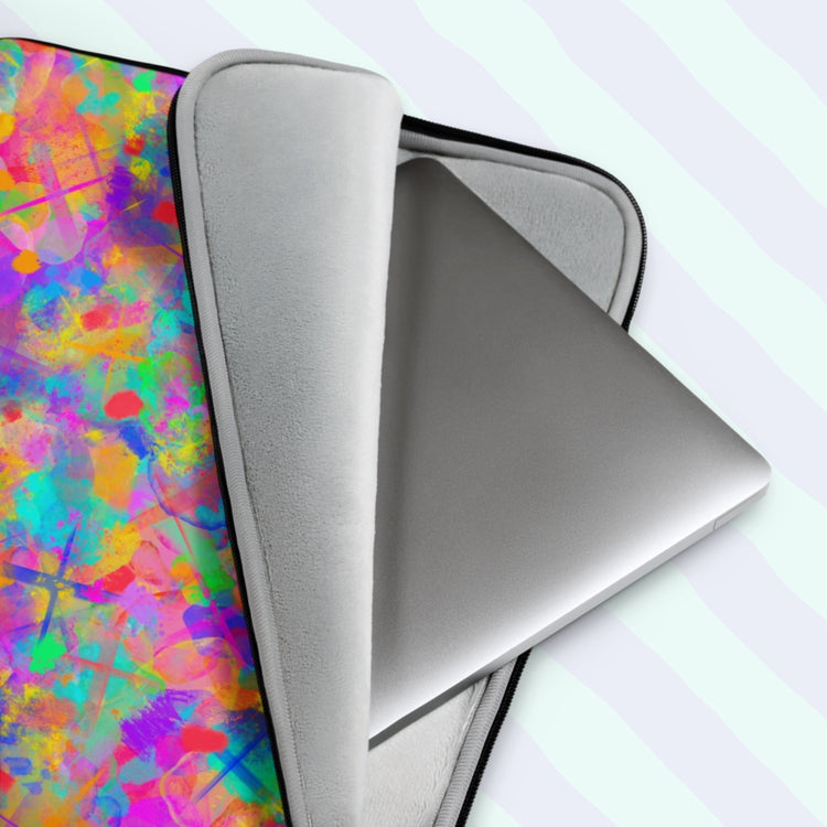 The Splotches and Crosses Laptop Sleeve from My Favourite Colour is Rainbow is a true tech statement piece. It features a vibrant design of splashes of colour and contrasting large cross shapes in pink, blue, yellow, orange and green. It has a great padded interior to keep your laptop safe from scratches.  The print is on only one side of the laptop sleeve, the other side is black. It is shown on a pastel background.