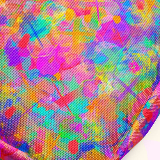 This abstract image, with multicolored patterns in pink, blue, green, and yellow hues, mirrors the dynamic appearance of the Splotches and Crosses Mini Crossbody Bag by My Favourite Colour is Rainbow. The design features varied shapes and textures with adjustable straps for added style.