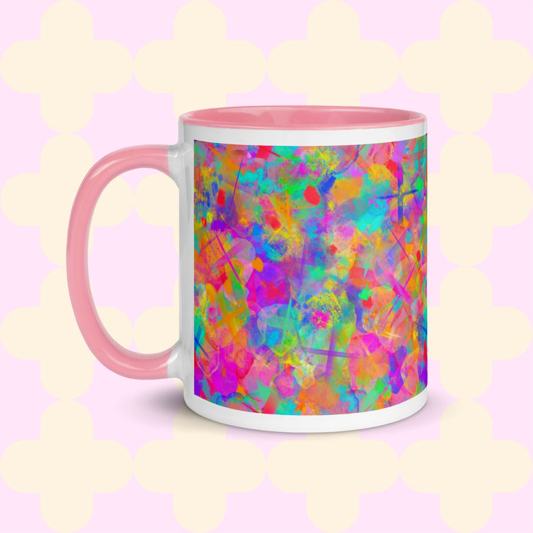 The Splotches and Crosses Mug by My Favourite Colour is Rainbow is a white mug with a pink interior and handle, featuring a vibrant abstract design with splashes of green, blue, pink, and orange.