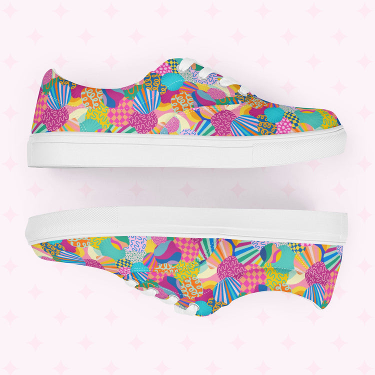 The Squiggs and Stripes Canvas Sneakers by My Favourite Colour is Rainbow combine vibrant style with a colorful abstract print of geometric shapes, swirls, and floral designs in pink, blue, green, orange, and yellow on a light background.